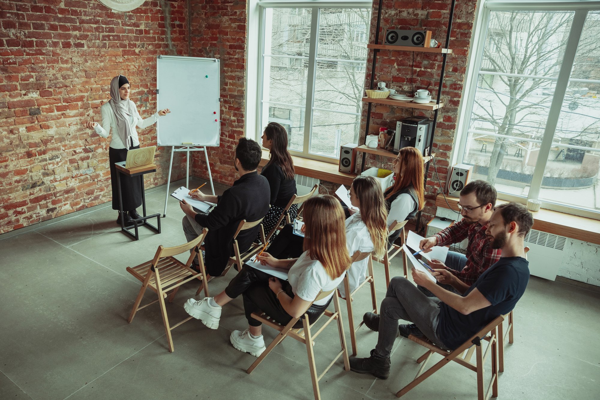 female-muslim-speaker-giving-presentation-hall-workshop-audience-hall-high-angle-view-participants-audience female-muslim-speaker-giving-presentation-hall-workshop-audience-hall-high-angle-view-participants-audience